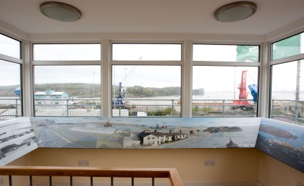 Room with large windows, harbour views, and photos from the Flying Boat Museum Foynes.