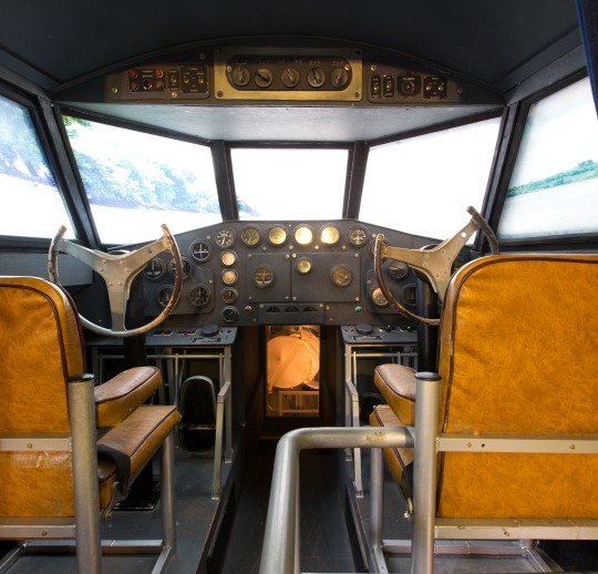 Vintage aeroplane cockpit with brown seats and control instruments at Foynes Museum.