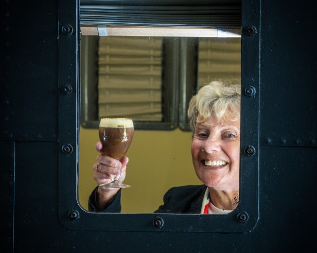 Elderly woman enjoys Foynes Irish Coffee at the Flying Boat Museum window.