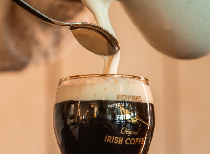Cream being poured onto Irish coffee at the Flying Boat Museum Foynes.