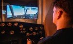 User operating the flight simulator at Flying Boat Museum Foynes with cockpit controls.